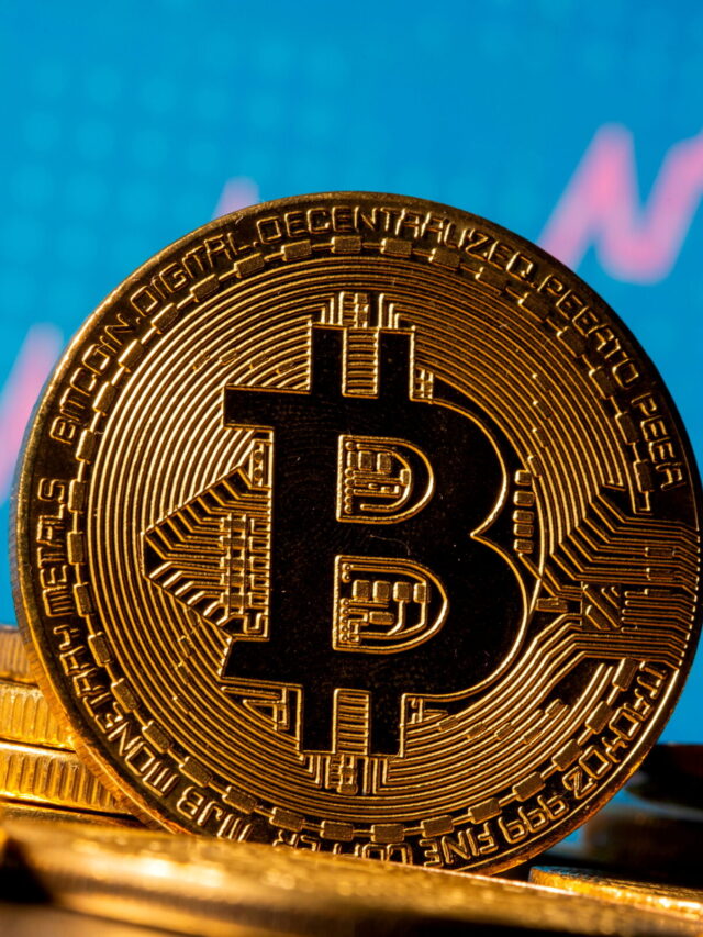 FILE PHOTO: A representation of virtual currency bitcoin is seen in front of a stock graph